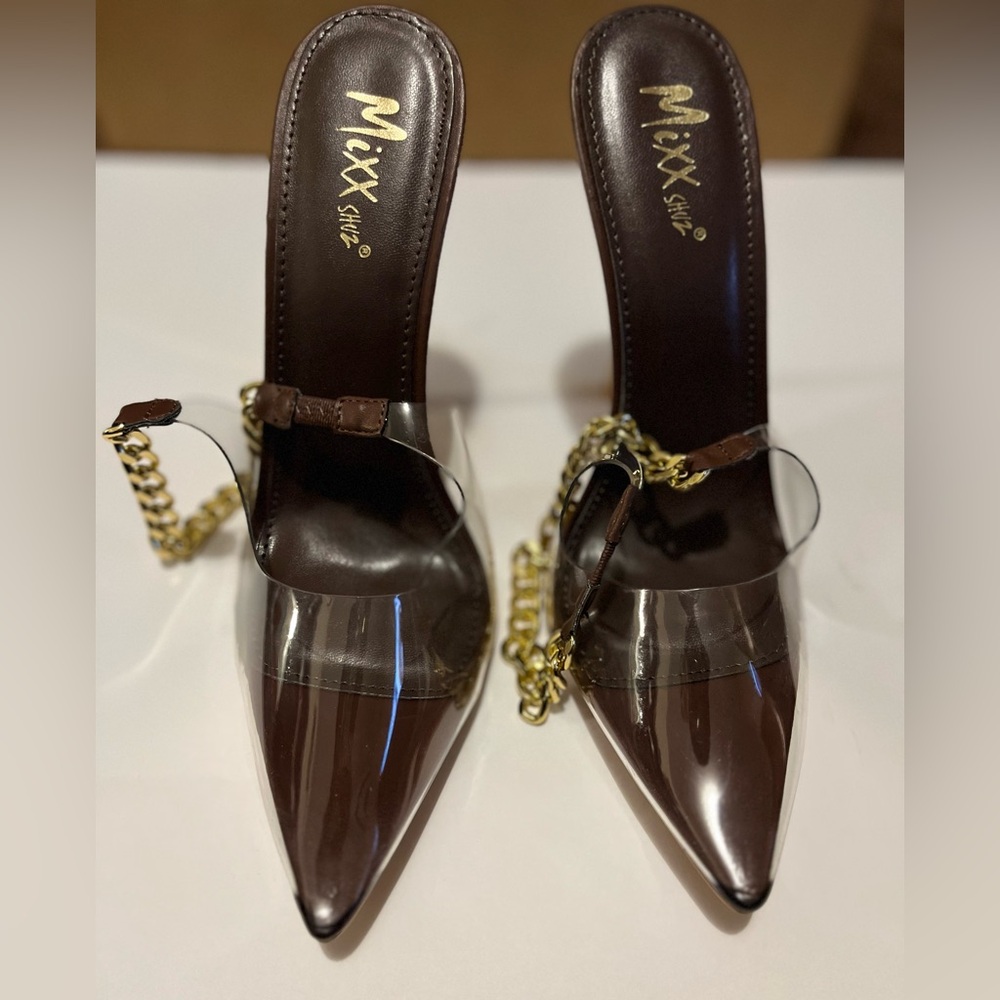 Brown stiletto heels with gold accents.